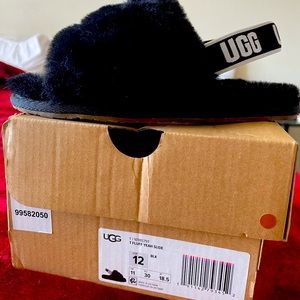 Kids Fluff Yeah Slides in a size 12 in black.